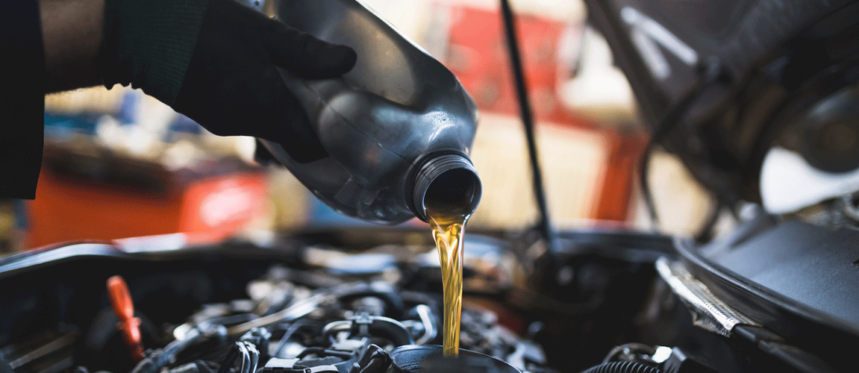 Maintenance worker performing oil change