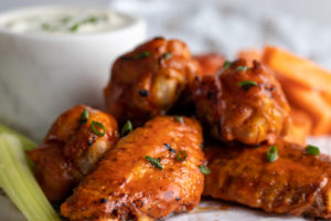 Buffalo chicken wings with bbq sauce and celery