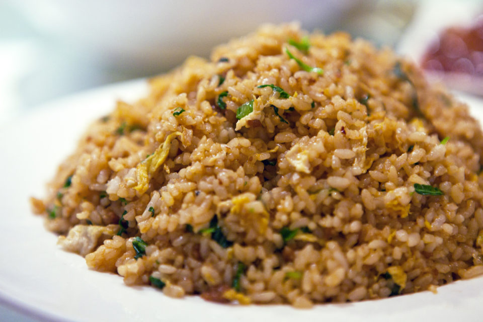 Soy sauce fried rice served in porcelain plate