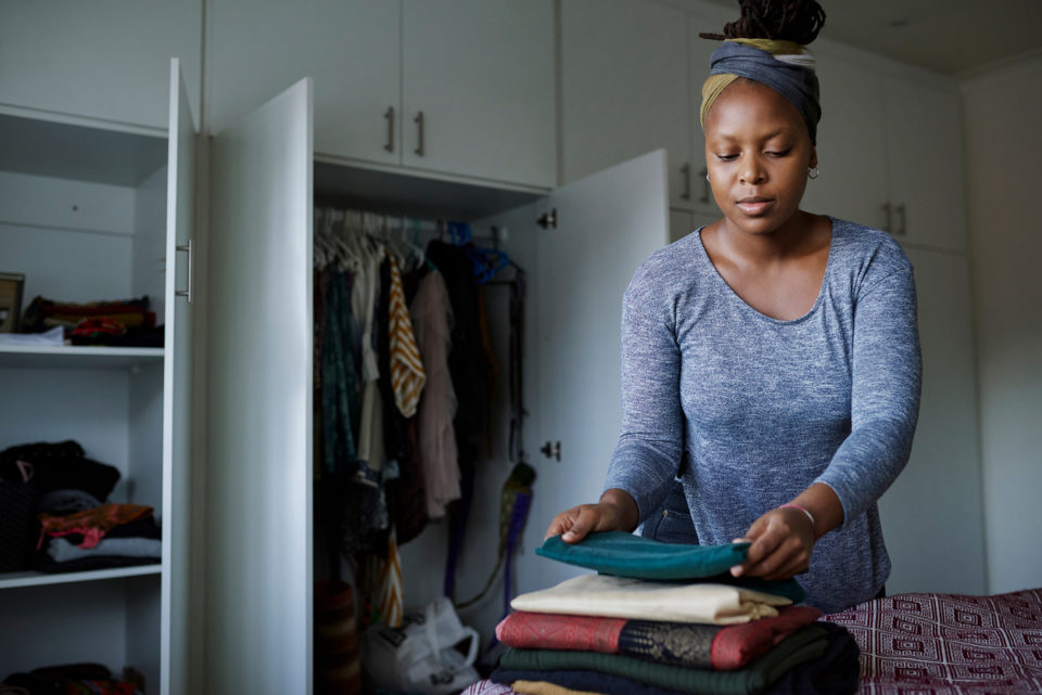 Cropped shot of a young woman folding her laundry at home