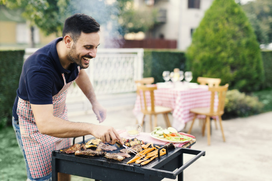 Man making BBQ in his yard