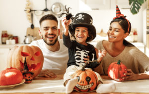 Happy family preparing for Halloween celebration