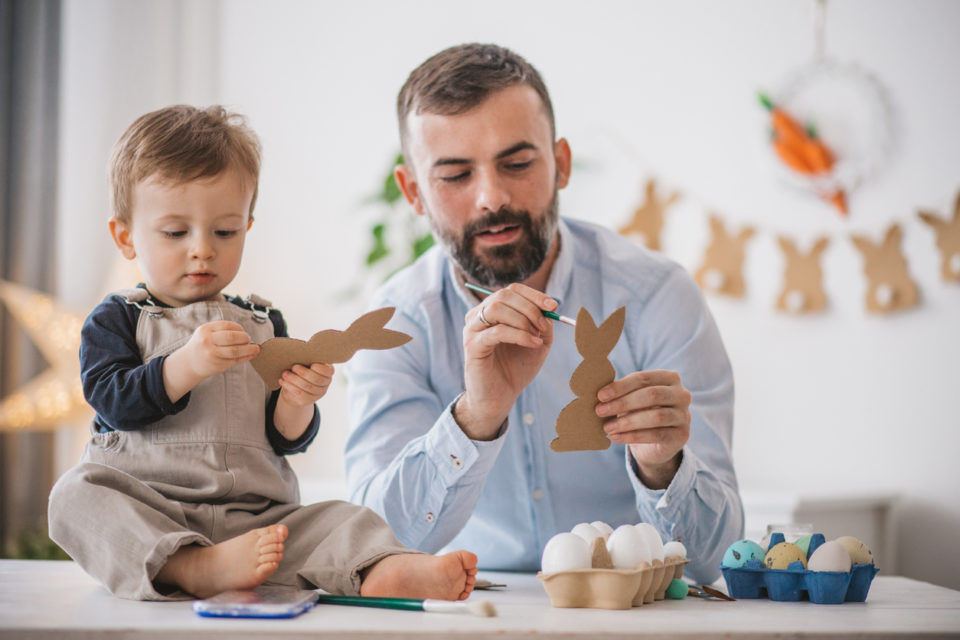 Father and son painting eggs and bunny's for Easter