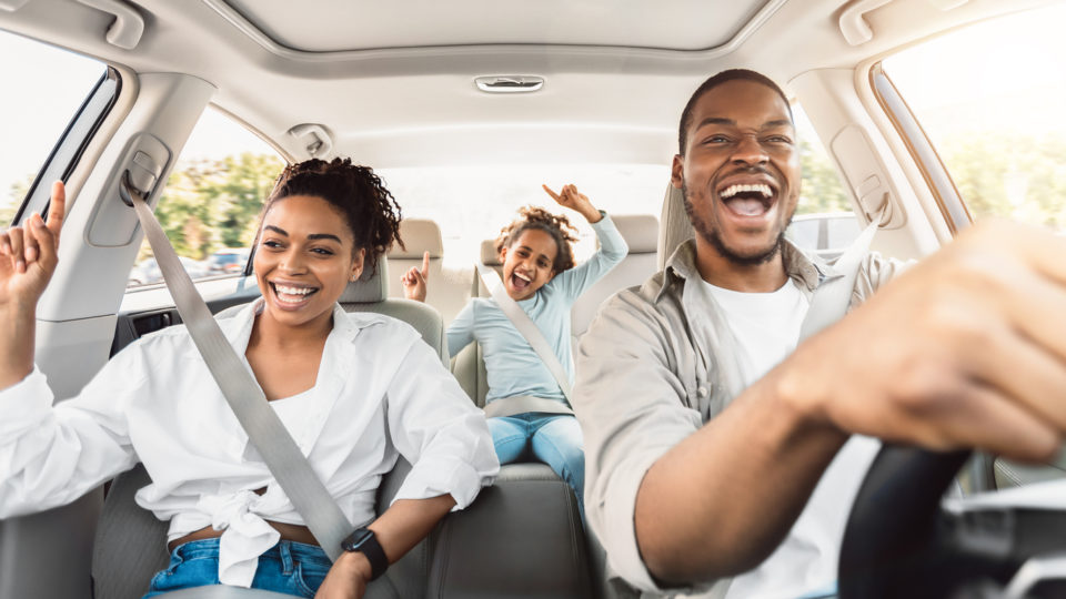 Family Of Three Singing Having Fun Riding Car