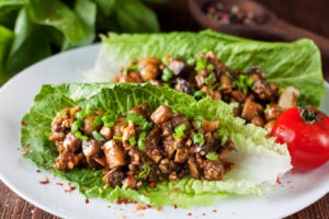 Vegetarian lettuce wraps with mushrooms, chestnuts, onion