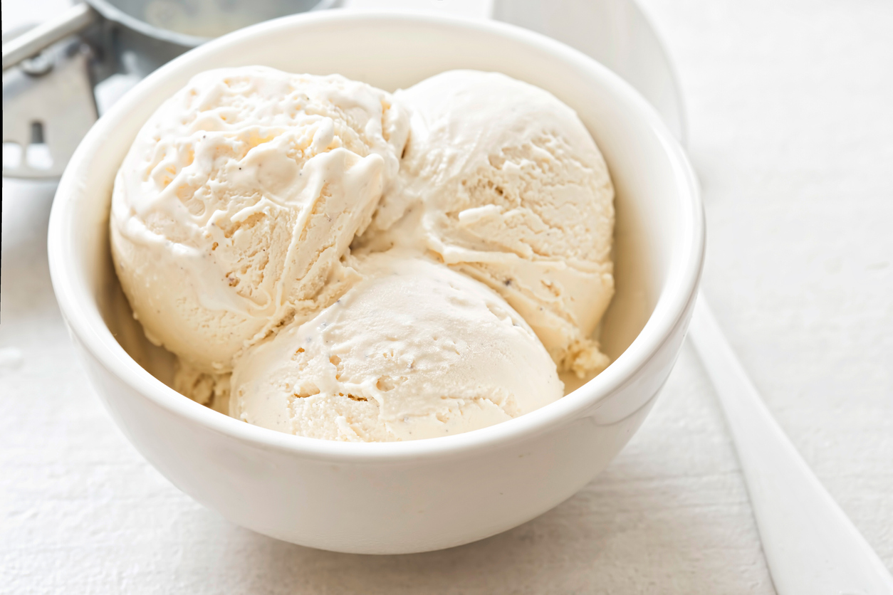 Vanilla ice cream scoops in white bowl