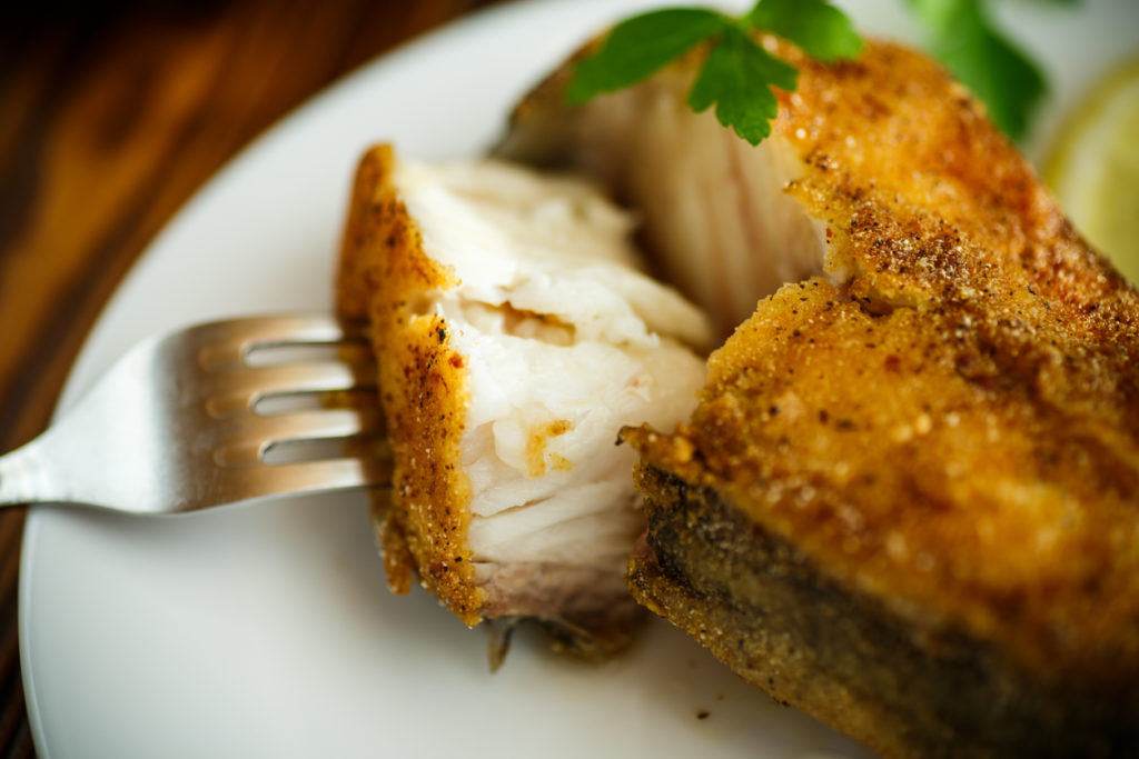 catfish roasted in batter on a wooden table