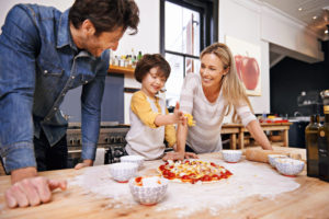 A family making pizza together at home