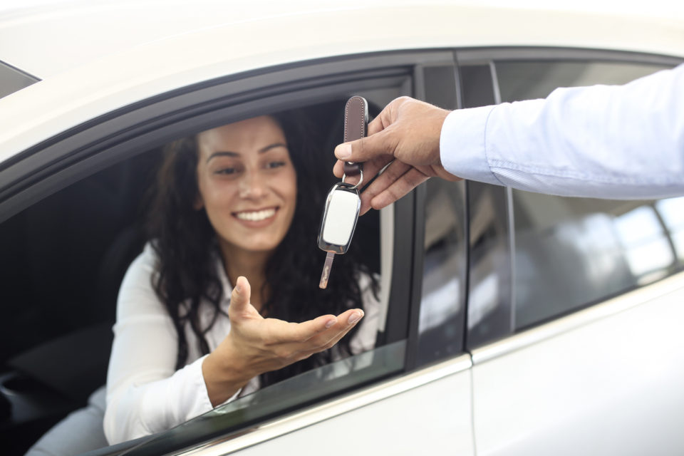 Female customer in her new car.