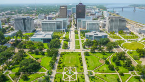 An aerial view of downtown Baton Rouge from the State Capitol building, looking towards the Mississippi bridge and river.