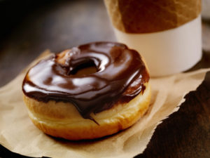 Chocolate Donut with a Take Out Coffee